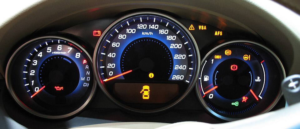 A car instrument cluster with a large speedometer marked in kilometers per hour, showing the speed at one moment but not the car's direction of travel.